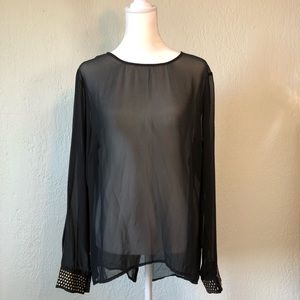 Sheer black long sleeved shirt. Gold rivet embellishment on sleeve cuffs & back.